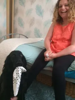 assistance dog passes sock to girl