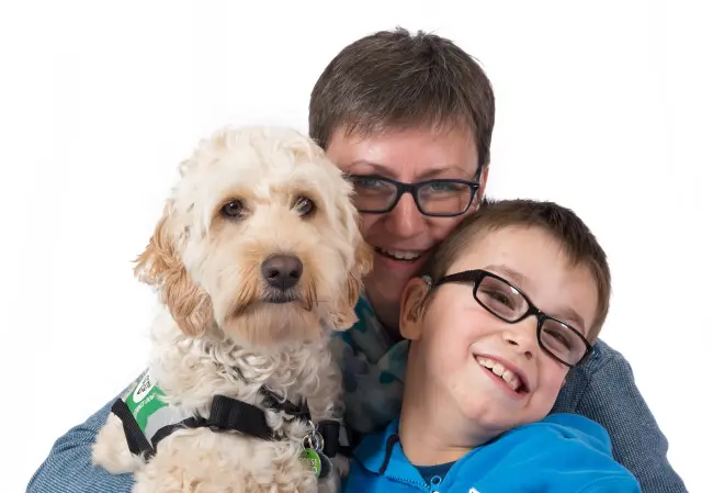 Assistance dog Elmo with family