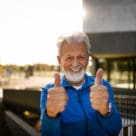 Portrait of a smiling senior man showing his thumbs up