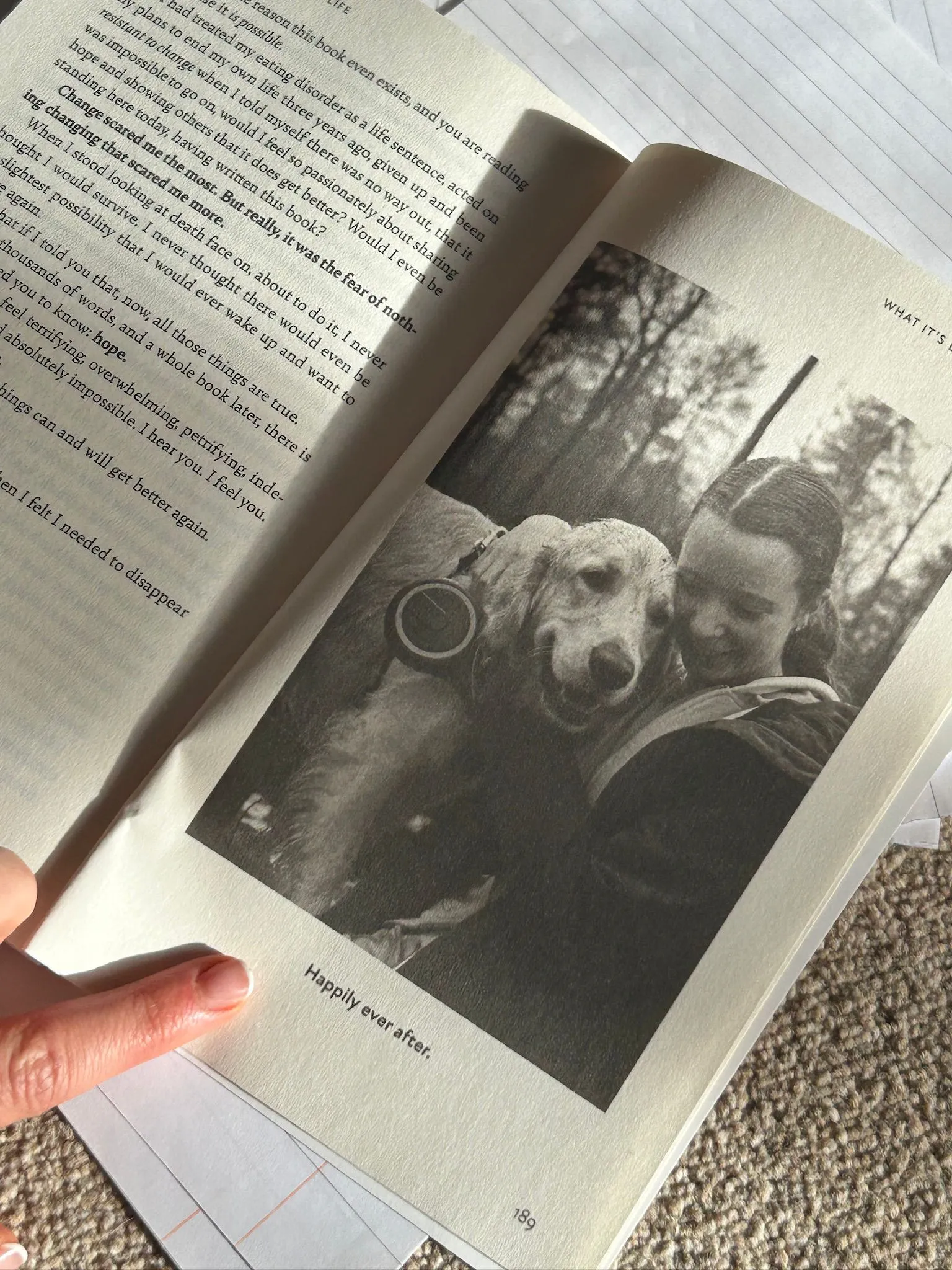 One of the inside pages of Rachel's book shows a black and white photograph of Rachel and Cruz on a muddy walk in the forest. The text underneath the photograph reads 'Happily ever after'.