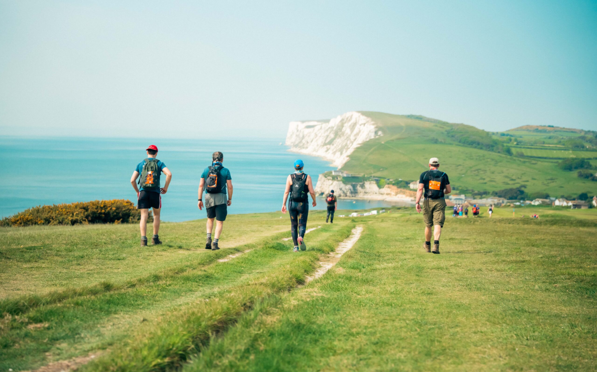 Isle Of Wight Ultra Challenge Participants Walking Along Coastal Path Scaled