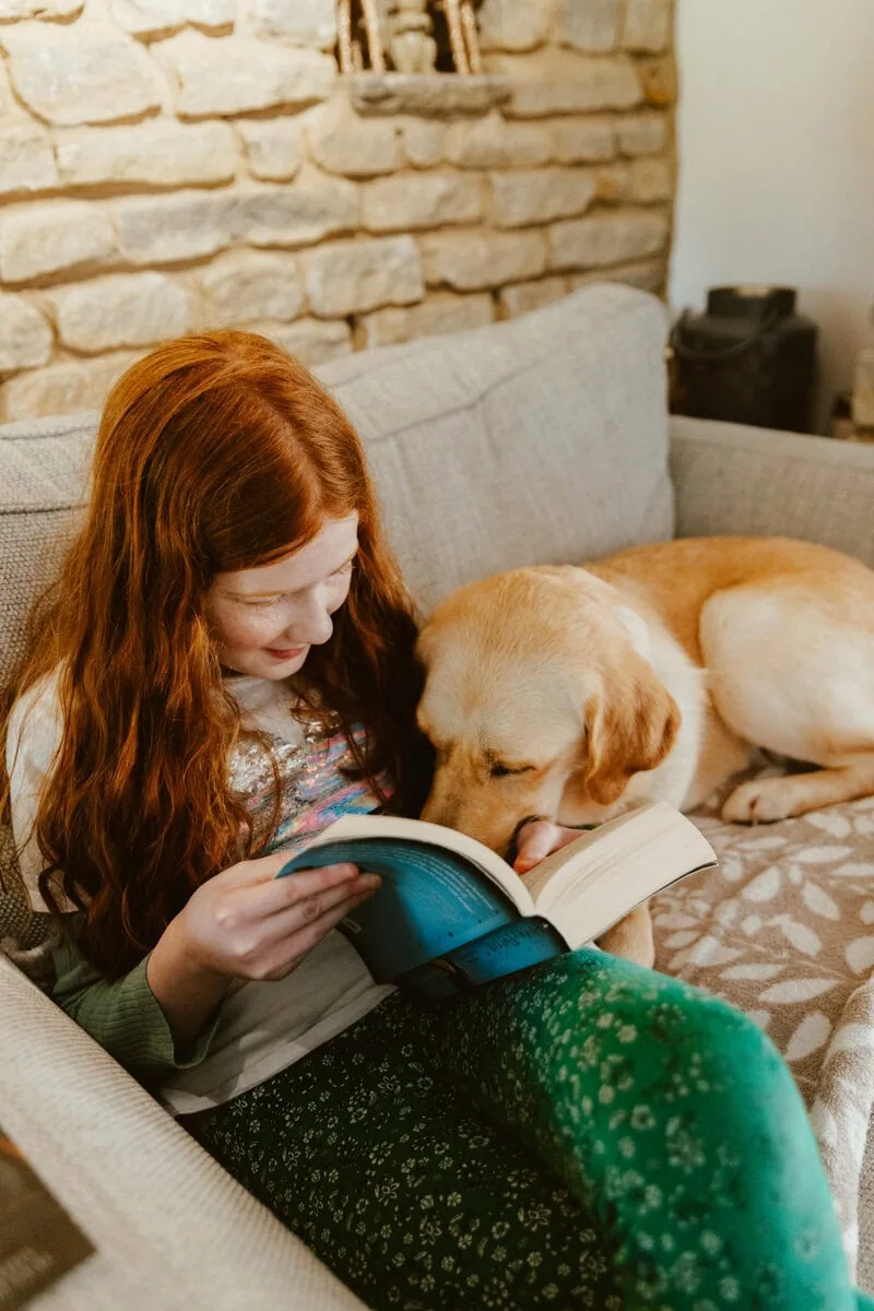 Autism Assistance Yellow Labrador Child Home Sofa Sitting Reading Bonding Sideview