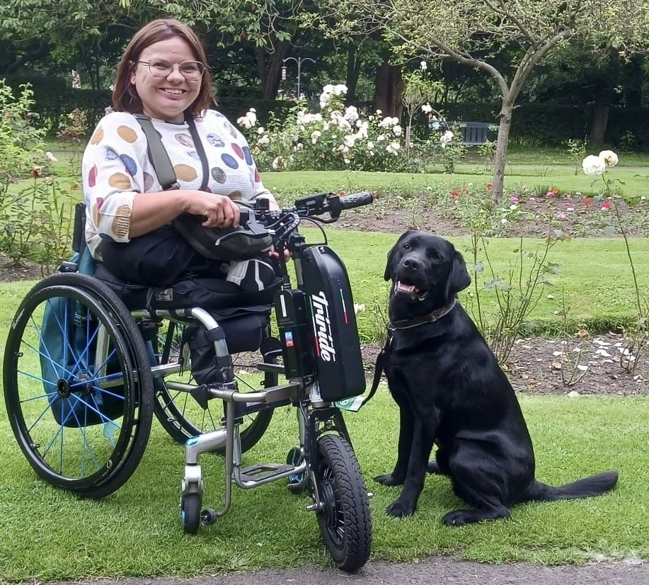 Nicolette and Kenny sitting in the park on the day they qualified as a partnership
