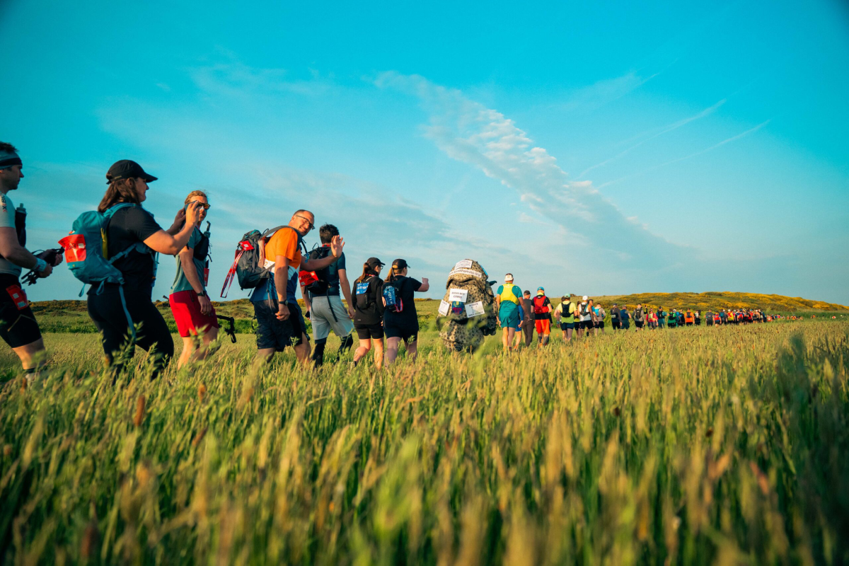 Lake District Ultra Challenge Participants Walking Through Field Scaled