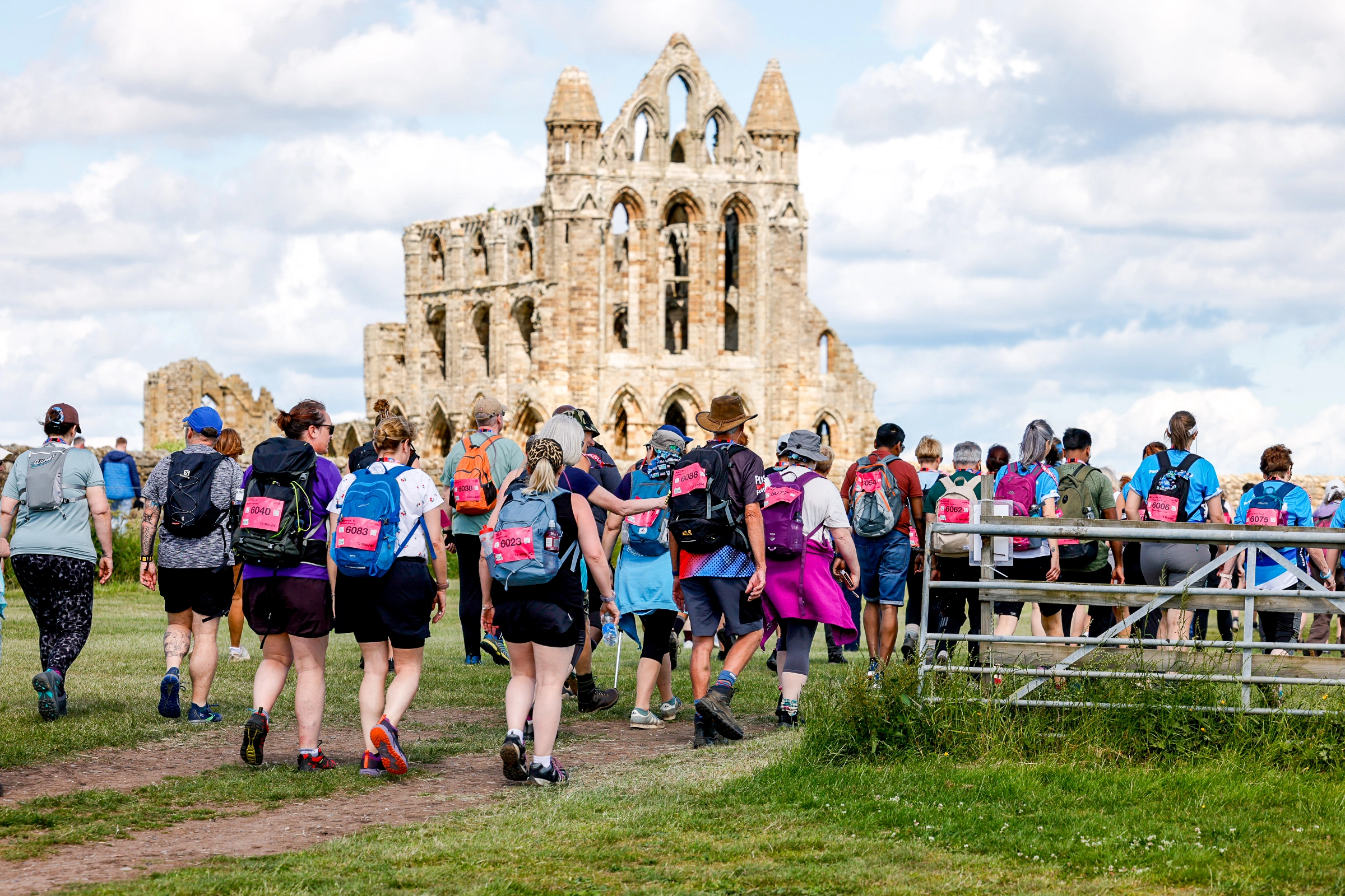 North Yorks Ultra Challenge participant walking past Whitby Abbey on a cloudy day