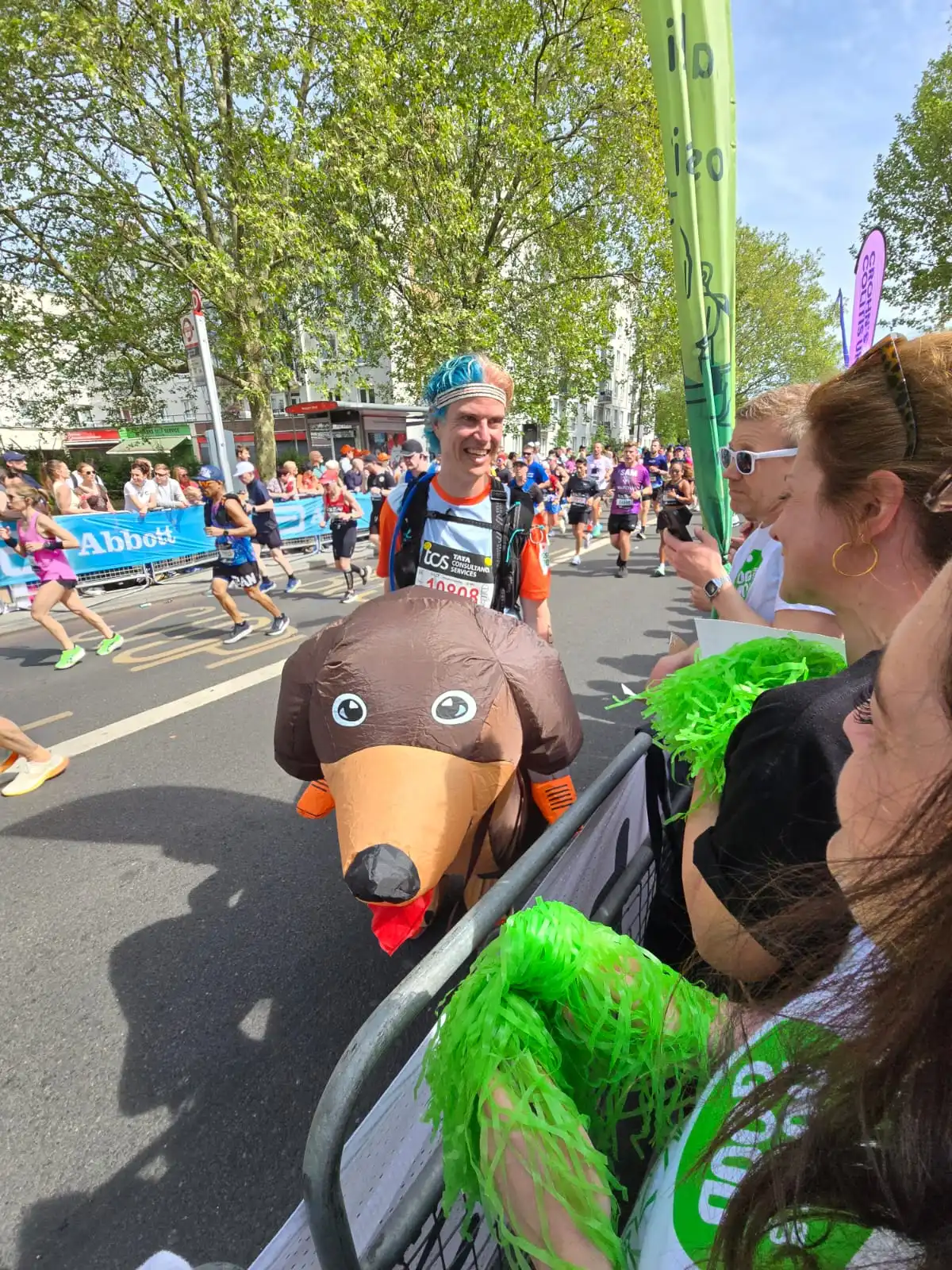 Dogs for Good fundraiser running London 2026 marathon in inflatable dog costume with blue and pink dyed hair