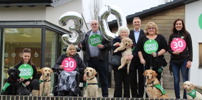 Clients, staff and volunteers with dogs and puppy 