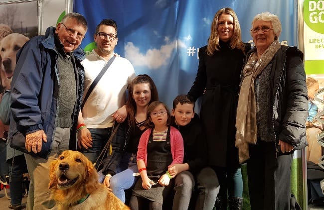 Milli with assistance dog Emma and her family on our stand at Crufts