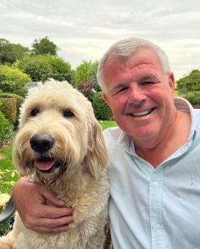 Photo of Cliff Hedley, Dog's for Good Director of Finance, and his dog Tilly